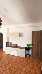 a living room with a cabinet and a potted plant at Casa Rural Cortijo Cerro Limon in Málaga
