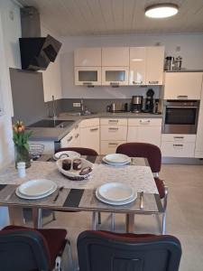 a kitchen with a table with plates on it at Ferienwohnung Wirtz in Olzheim