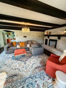 a living room with a couch and a rug at The Joyful Escape in Crewe
