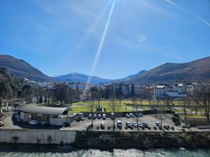 a group of cars parked in a parking lot with a rainbow at Villa l'Orante in Lourdes +8 photos