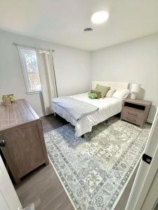 a bedroom with a bed and a rug at Crewe Corner Apartment C in Crewe