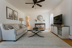 a living room with a couch and a flat screen tv at Pine Creek Farm in Burkeville