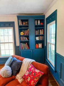 a living room with a couch and a book shelf at The Joyful Escape in Crewe