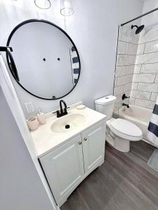 a bathroom with a sink and a mirror and a toilet at Crewe Corner Apartment C in Crewe +18 photos