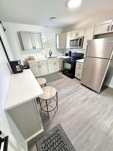 a kitchen with white cabinets and a stainless steel refrigerator at Crewe Corner Apartment C in Crewe