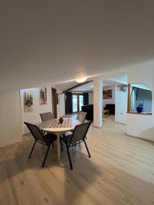 a dining room and living room with a table and chairs at Villa Fantasy Premium Lakeview in Ohrid