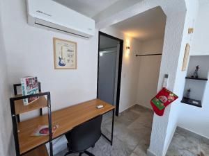 a small room with a desk and a hallway at Casa Secretos del Sol in Acapulco