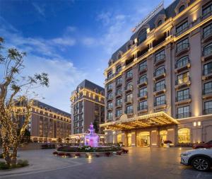 a hotel with a fountain in front of a building at Imperial Dalat Hotel, BW Premier Collection in Da Lat