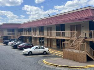 a car parked in a parking lot in front of a motel at UNIVERSITY INN Winston in Winston-Salem