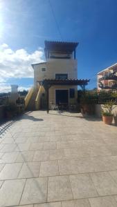 a building with a patio in front of it at LifeHouse in Agia Pelagia