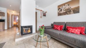 a living room with a couch and a fireplace at Ferienlandhaus Alpinum in Lenggries