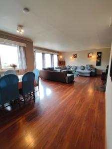 a living room with a couch and a table and chairs at Stryn Norway in Stryn