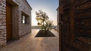an open door with a tree in a courtyard at Anima Ocean Lodges in Essaouira
