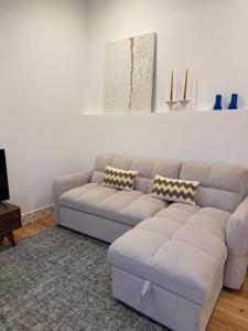 a living room with a couch and a table at Casa da Ana - Casinhas com Alma in Torrão +7 photos