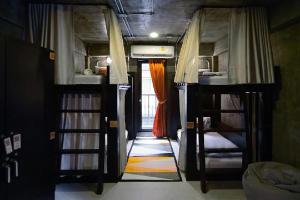 a hallway with two bunk beds in a room at Photohostel in Bangkok