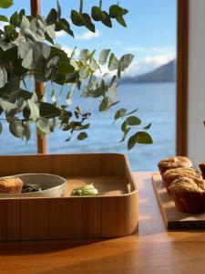 a wooden tray with food on a table with a window at Anzan Atitlan in San Marcos La Laguna
