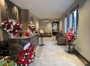 a lobby with flowers on display in a building at Lam Anh Hotel 10 Ngoai Giao Doan in Hanoi