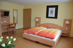 una camera da letto con un letto, una scrivania e una scrivania di Hotel Gasthof Kreuz a Welschenrohr