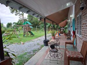 a patio with tables and chairs and a playground at Hotel Casa Pueblo in Ocú