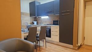 a kitchen with blue cabinets and a table and chairs at Guest house Di Carlo in Sulmona
