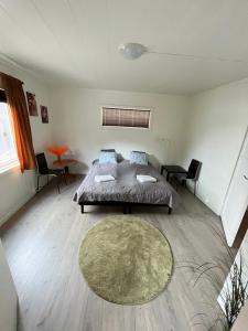 a bedroom with a bed and a table and chairs at Green apartment in Odda