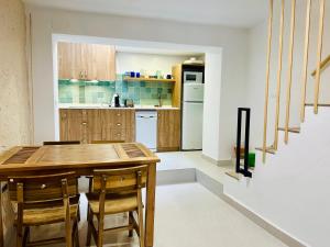 a kitchen with a wooden table and chairs at La casa del pinsapo in Yunquera