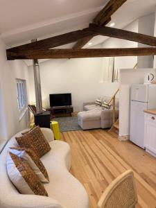 a living room with two couches and a tv at Casa da Ana - Casinhas com Alma in Torrão