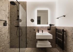 a bathroom with a sink and a shower at Limehome Wels Ringstraße in Wels