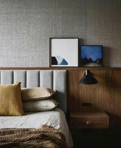 a bedroom with a bed with two pictures on the wall at The Lakeview Guesthouse in Duluth