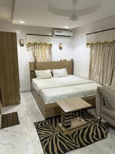 a bedroom with a large bed and a zebra rug at Majesty Apartment in Asaba