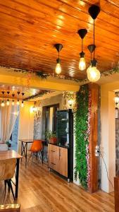 a living room with a wooden ceiling with a green wall at Old Tatev Guesthouse in Tatʼev +36 photos