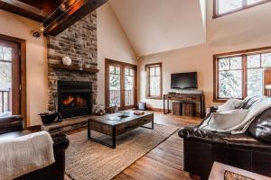a living room with a couch and a fireplace at Chalet Le Mont-Blanc in Saint-Faustin