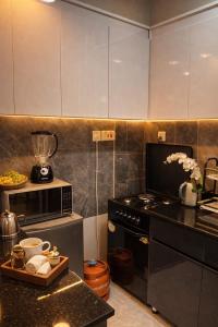 a kitchen with a stove and a blender on a counter at Cozy Apartment in Munyonyo in Munyonyo