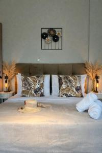 a bedroom with a large bed with pillows at Allure villa in Porto Rafti
