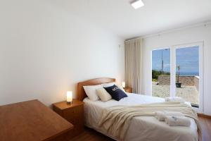 a bedroom with a bed with a view of the ocean at T3-Sitio do Surf in Nazaré +30 photos