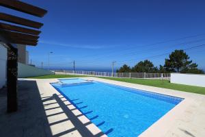 a swimming pool on the side of a house at T3-Sitio do Surf in Nazaré