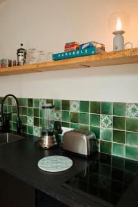 a kitchen counter with a toaster on a counter top at The Little Hideaway - La Petite Maison Cachée in Noyers