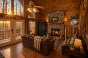 a living room with a couch and a fireplace at Alpine Joy in Townsend