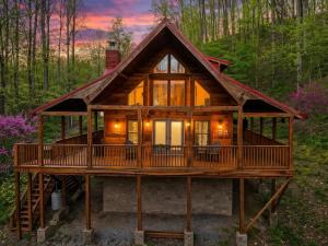 a large wooden house in the woods at Alpine Joy in Townsend