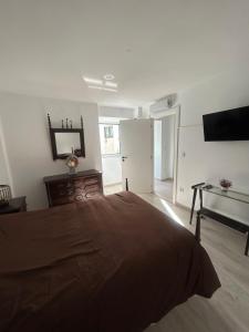 a bedroom with a bed and a desk and a television at Encanto do Rio in Bragança