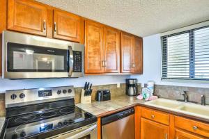 a kitchen with a stove and a microwave at SunDestin Resort Unit 0615 in Destin
