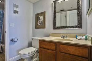 a bathroom with a sink and a toilet and a mirror at SunDestin Resort Unit 0615 in Destin