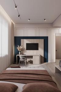 a bedroom with a large bed and a tv at Gradska Palača - BOSANA Hotel & Spa in Bihać +2 photos