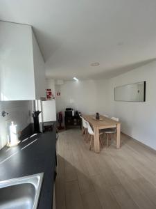 a kitchen with a table and a dining room at Encanto do Rio in Bragança