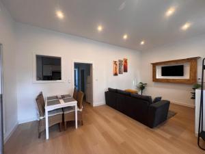 a living room with a couch and a table at Apartment Rosenberg in Klotten