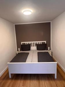a bedroom with a white bed with two pillows at Apartment Rosenberg in Klotten