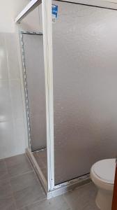 a shower stall in a bathroom with a toilet at Cabaña El Tucan in Minca