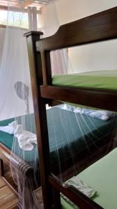 a top bunk bed in a room with a window at Cabaña El Tucan in Minca
