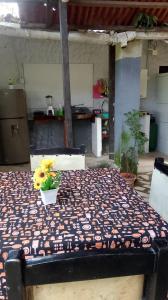 a table with a vase of flowers on top of it at Cabaña El Tucan in Minca +26 photos