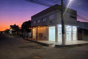 a building with lit up windows on a street at Flat Adenil Falcão - By Temporada Expert -Moderno e Próximo ao centro in Feira de Santana